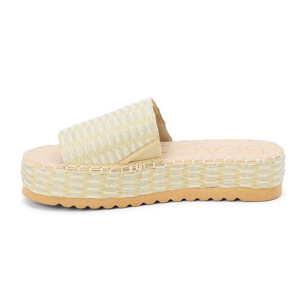 Green and ivory platform slide sandal with woven vegan raffia upper and thick sole, shown on a white background.