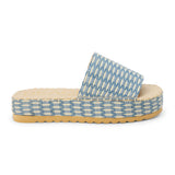 Blue and ivory platform slide sandal with woven vegan raffia upper and thick sole, shown on a white background.