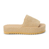 Gold platform slide sandal with woven vegan jute upper and thick sole, shown on a white background.
