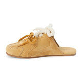 Tan suede sneaker mule with ivory shearling trim, tan laces, stitched detailing, and a flat sole shown on a white background.