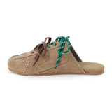 Taupe suede sneaker mule with green and brown laces, stitched detailing, and a flat sole shown on a white background.