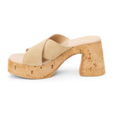 Beige suede platform sandal with wide crossover straps and cork block heel, shown on a white background.