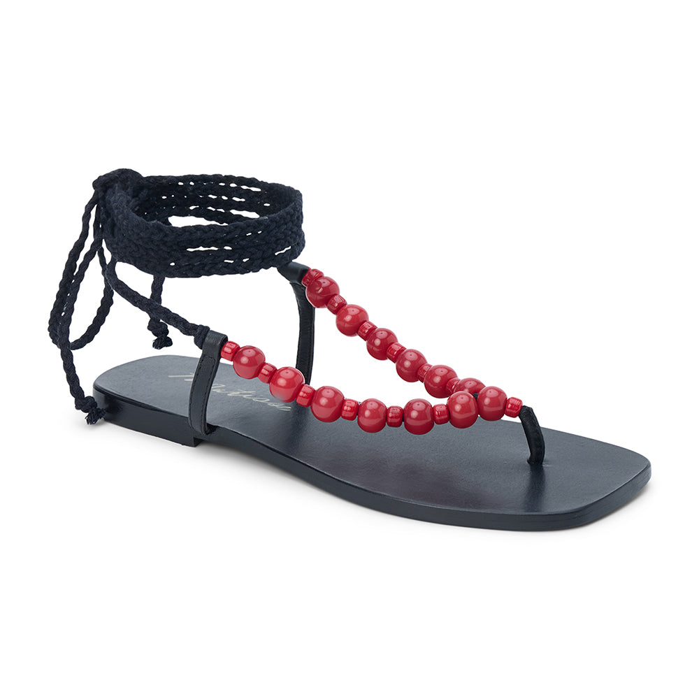 Black thong sandal with braided ankle wrap straps and red bead accents shown on a white background.