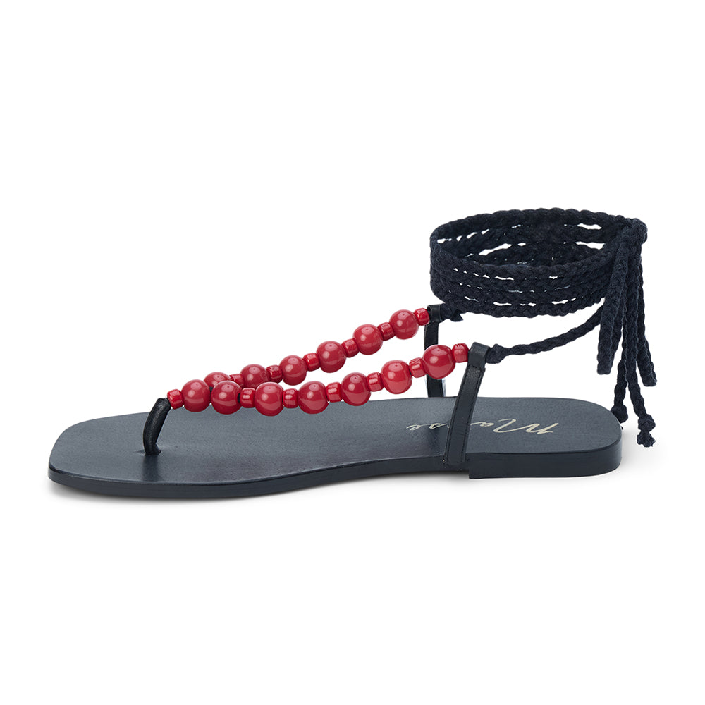 Black thong sandal with braided ankle wrap straps and red bead accents shown on a white background.