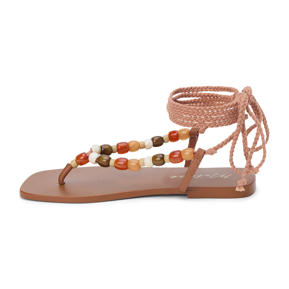 Tan thong sandal with braided ankle wrap straps and multicolor bead accents shown on a white background.