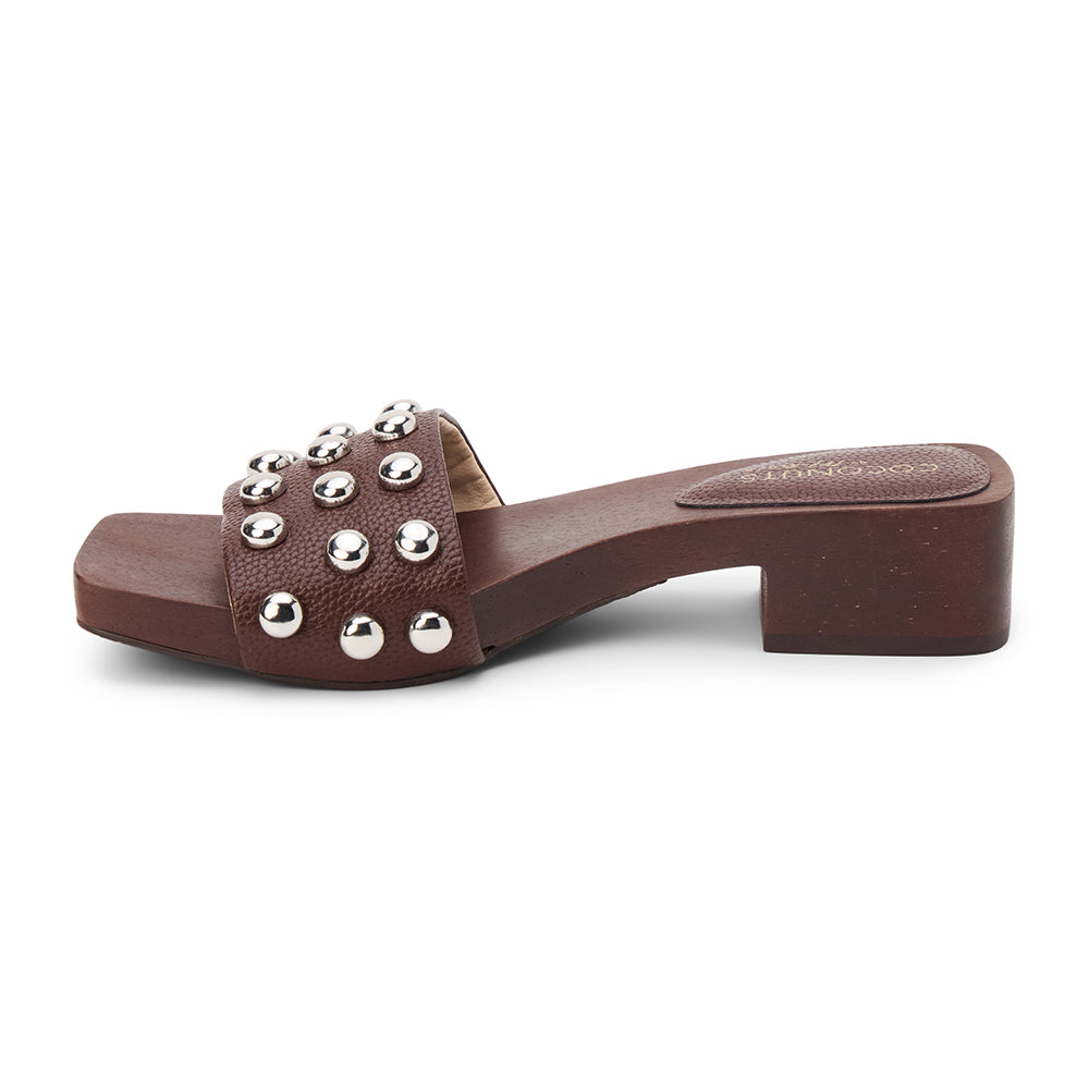 Brown vegan slide sandal with silver stud accents and low block heel, shown on a white background.