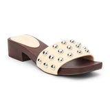 Light yellow vegan slide sandal with silver stud accents and low block heel, shown on a white background.