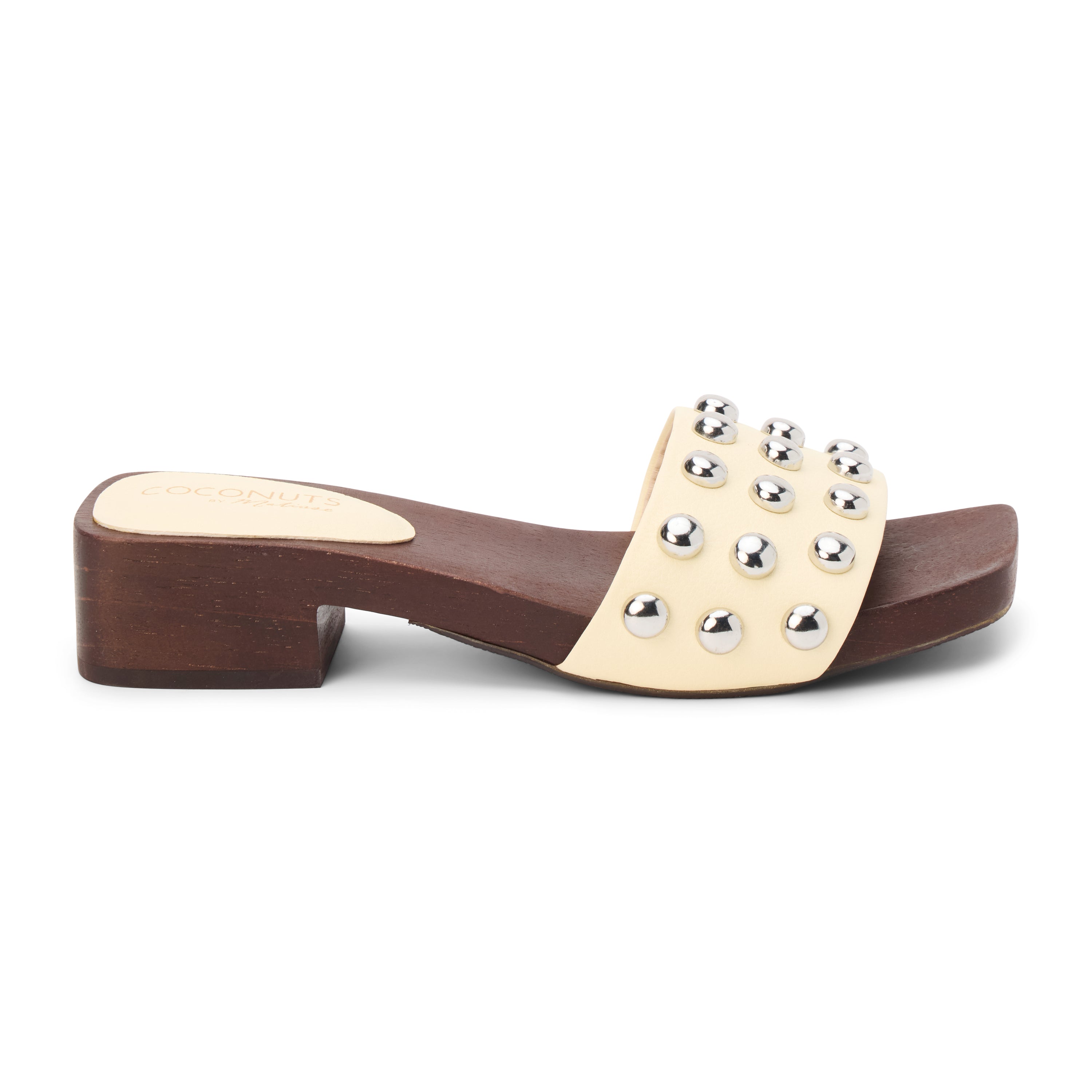 Light yellow vegan slide sandal with silver stud accents and low block heel, shown on a white background.