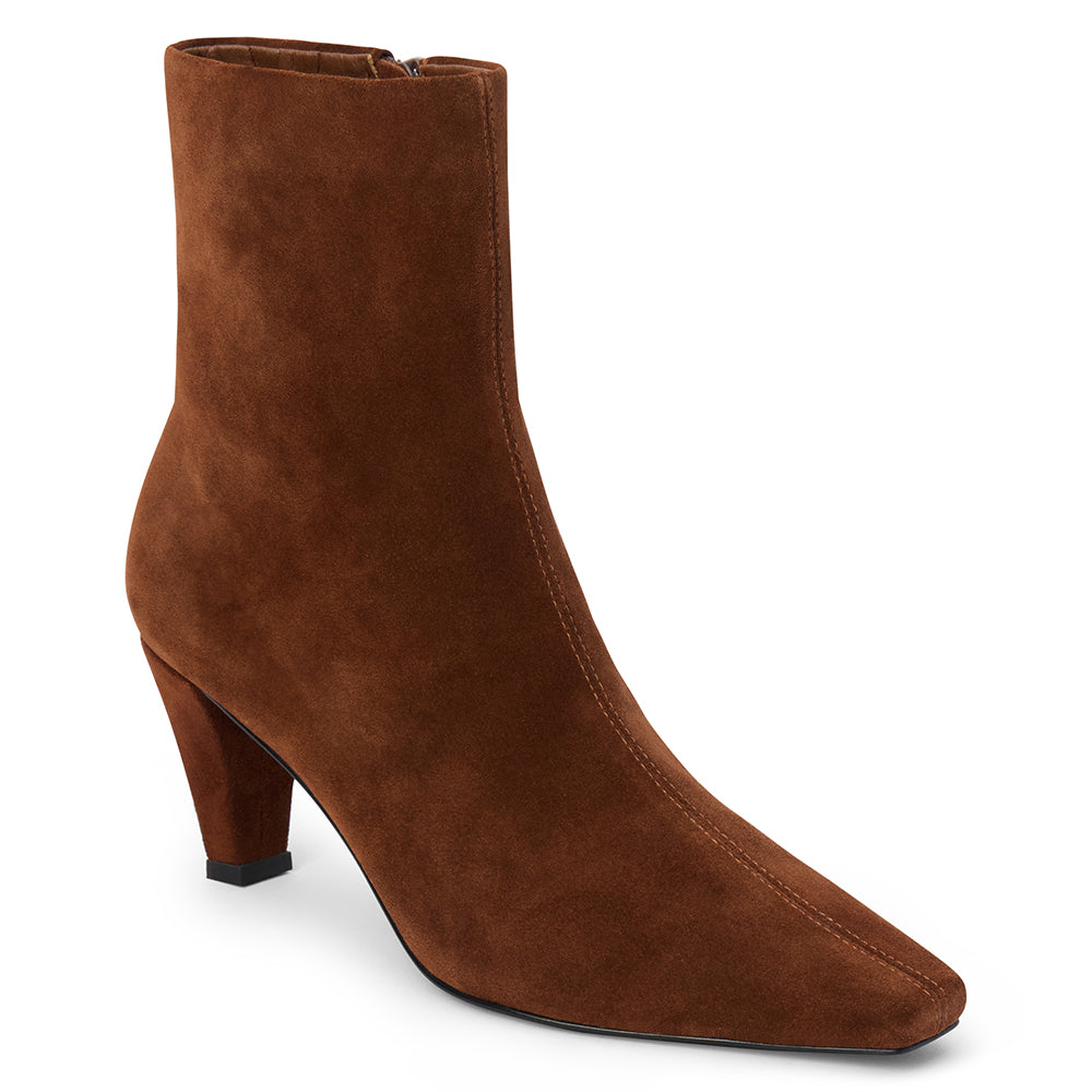 Brown suede ankle boot with a squared toe, slim tapered heel, and minimalist upper shown on a white background.