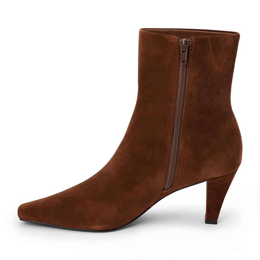 Brown suede ankle boot with a squared toe, slim tapered heel, and minimalist upper shown on a white background.