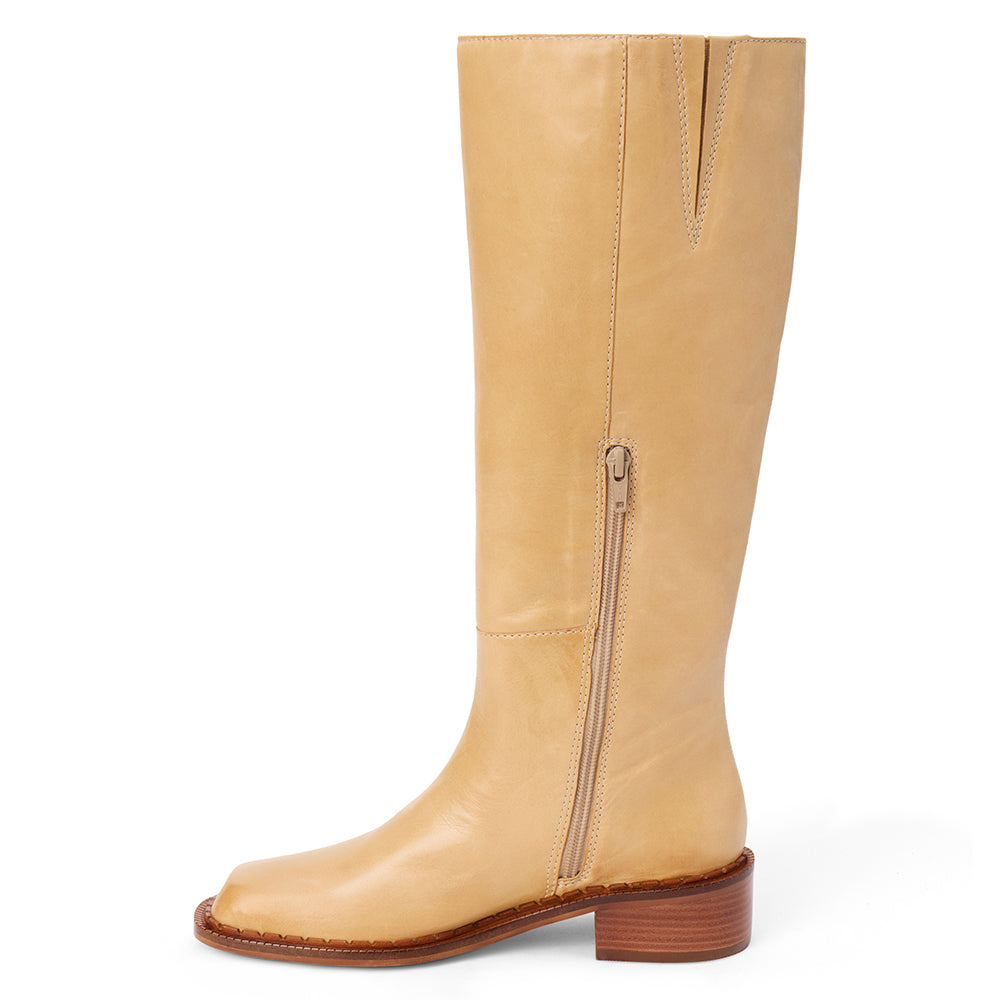 Tan leather knee-high boot with a rounded toe, low block heel, and smooth upper shown on a white background.