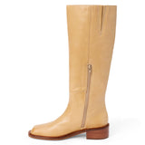 Tan leather knee-high boot with a rounded toe, low block heel, and smooth upper shown on a white background.