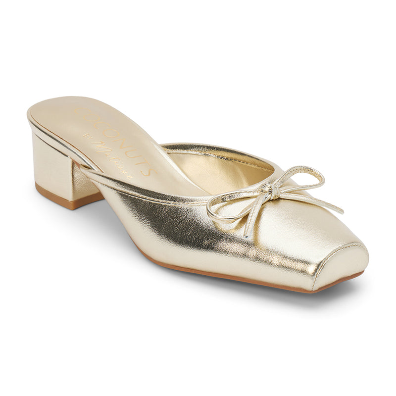 Geneva Heeled Mule – Coconuts by Matisse – Gold colored mule with a square toe, low block heel, and delicate bow detail.