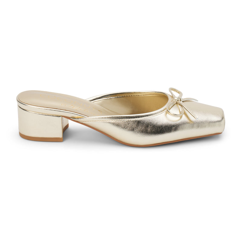 Geneva Heeled Mule – Coconuts by Matisse – Gold colored mule with a square toe, low block heel, and delicate bow detail.