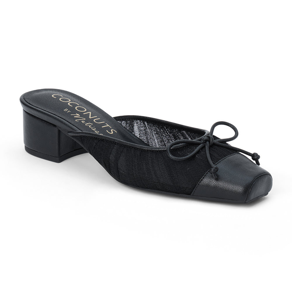 Vegan black mesh heeled mule with a square toe, tonal bow detail, solid toe cap, and low block heel shown on a white background.