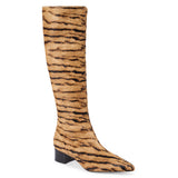 Tan cow hair knee-high boot with black zebra stripes, a pointed toe, tall shaft, and black low block heel shown on a white background.