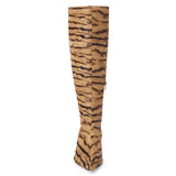 Tan cow hair knee-high boot with black zebra stripes, a pointed toe, tall shaft, and black low block heel shown on a white background.