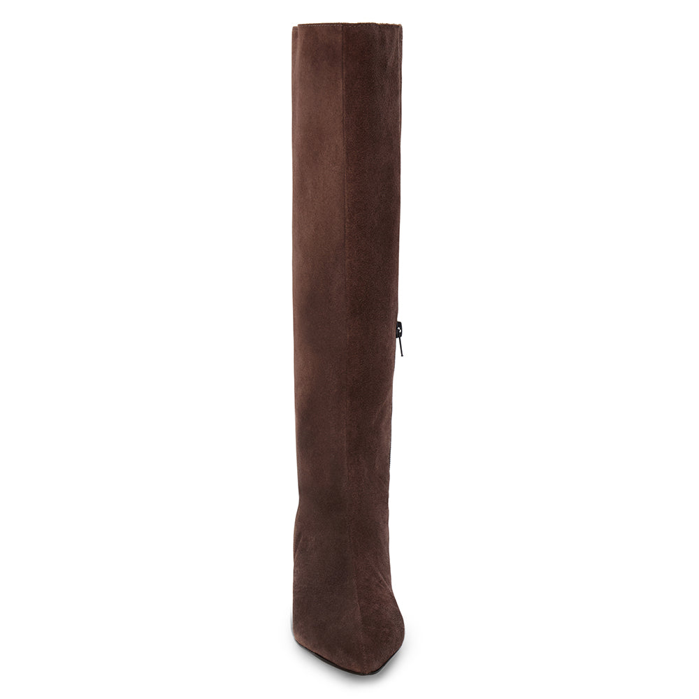 Brown suede knee-high boot with a streamlined tall shaft, pointed toe, and black low block heel shown on a white background.