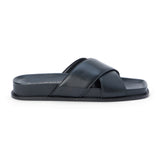 Black slide sandal with wide leather crossover straps and a cushioned sole, shown on a white background.