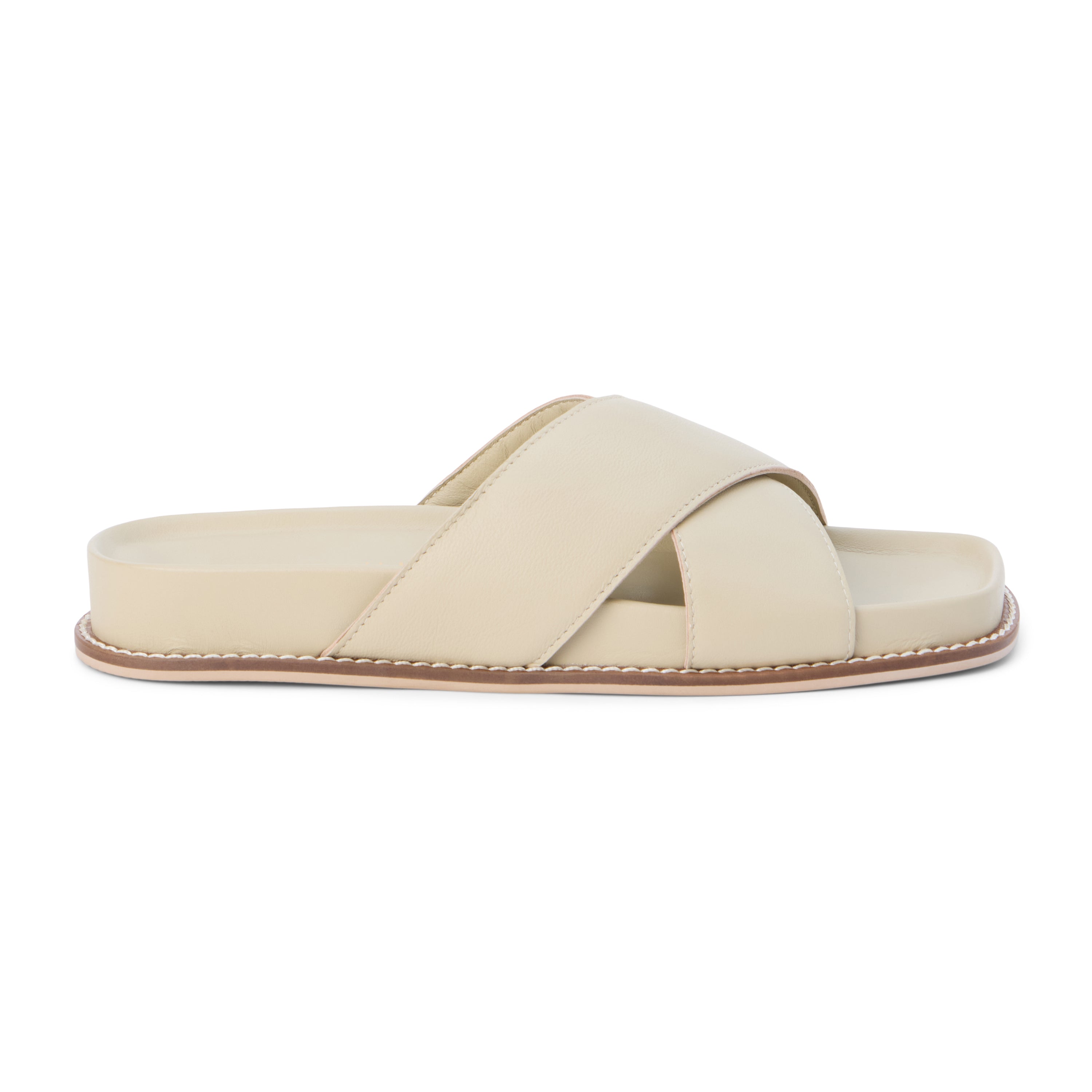 Ivory slide sandal with wide leather crossover straps and a cushioned sole, shown on a white background.