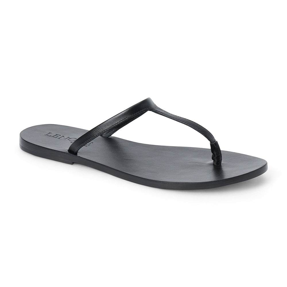 Black leather flat thong sandal with slim straps and minimalist design, shown on a white background.