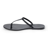 Black leather flat thong sandal with slim straps and minimalist design, shown on a white background.