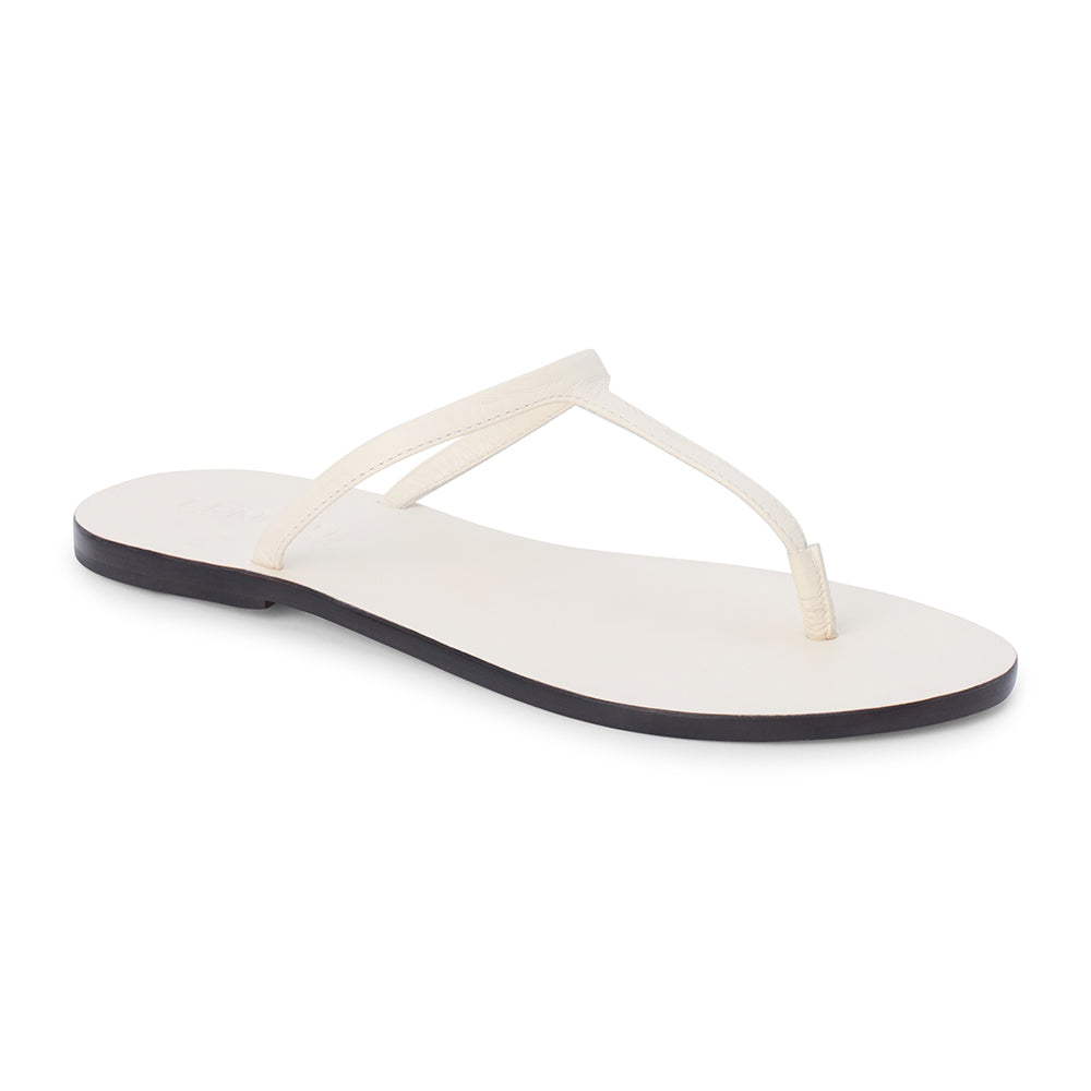 Ivory leather flat thong sandal with slim straps and minimalist design, shown on a white background.