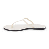 Ivory leather flat thong sandal with slim straps and minimalist design, shown on a white background.