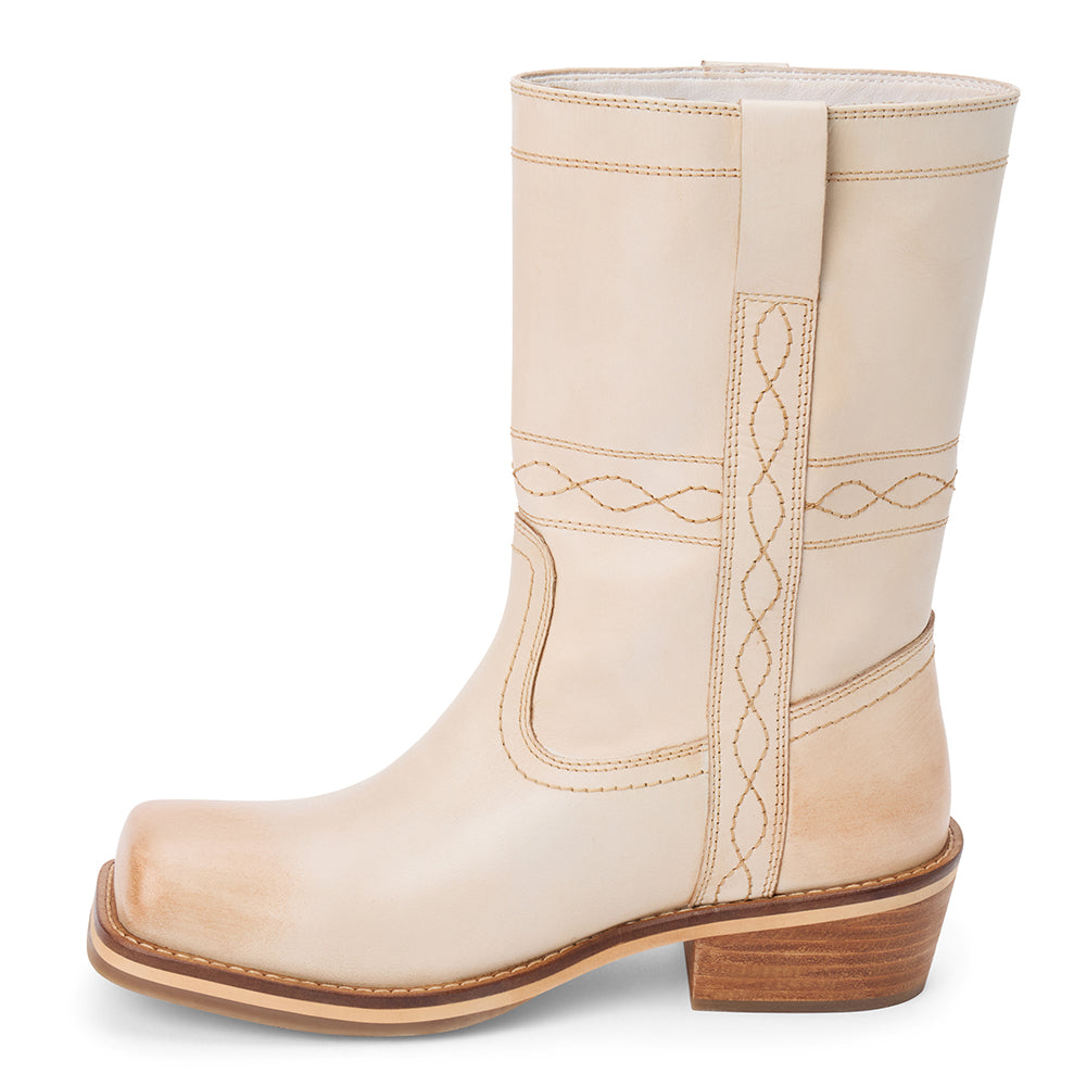 Ivory leather mid-calf boot with western stitching, pull tab, and a low stacked heel, shown on a white background.