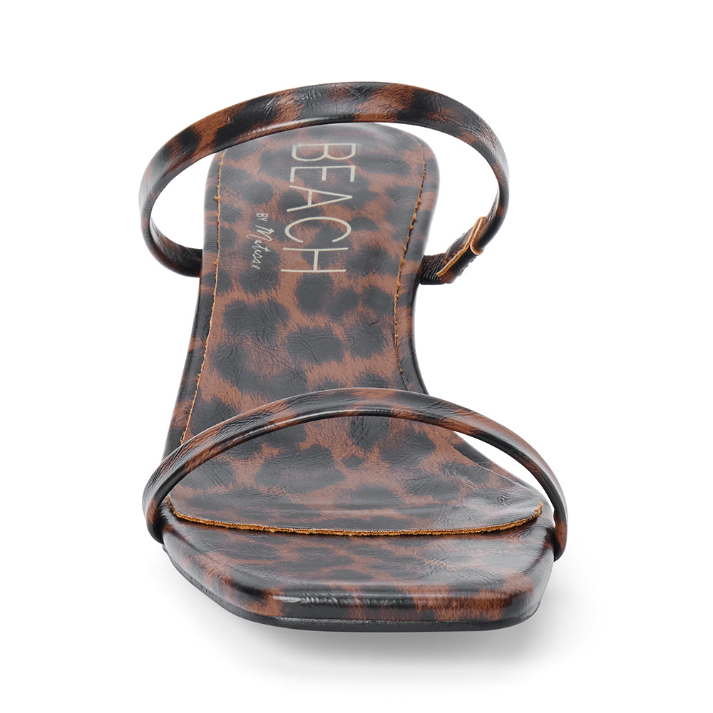 Vegan brown and black leopard-print faux leather sandal with slim straps, a square toe, and low kitten heel shown on a white background.