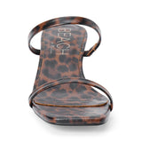 Vegan brown and black leopard-print faux leather sandal with slim straps, a square toe, and low kitten heel shown on a white background.