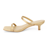 Vegan tan satin sandal with slim toe and instep straps, a square toe, and low kitten heel shown on a white background.