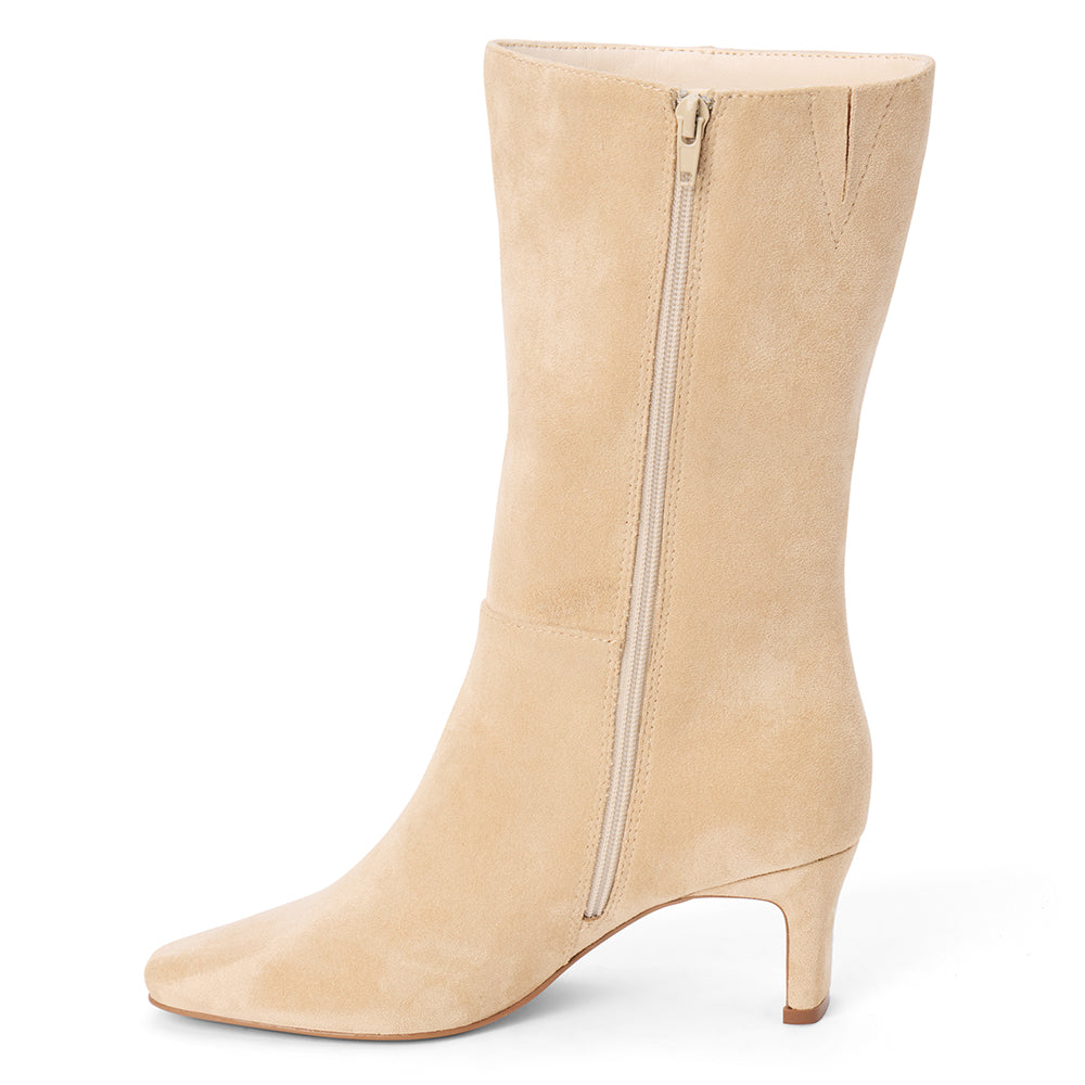 Vegan tan faux suede mid-calf boot with a streamlined shaft, square toe, tonal stitching, and slim heel shown on a white background.