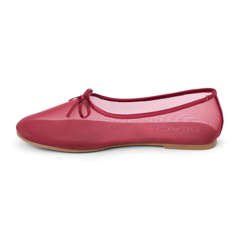 Vegan burgundy sheer mesh ballet flat with a rounded toe, tonal trim, matching toe panel, and small bow detail shown on a white background.