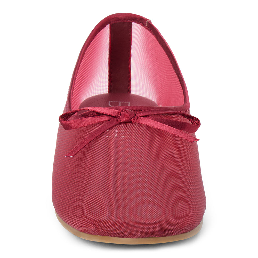 Vegan burgundy sheer mesh ballet flat with a rounded toe, tonal trim, matching toe panel, and small bow detail shown on a white background.