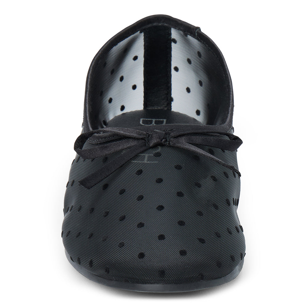 Vegan black sheer mesh ballet flat with black polka dots, a rounded toe, tonal trim, and small bow detail shown on a white background.