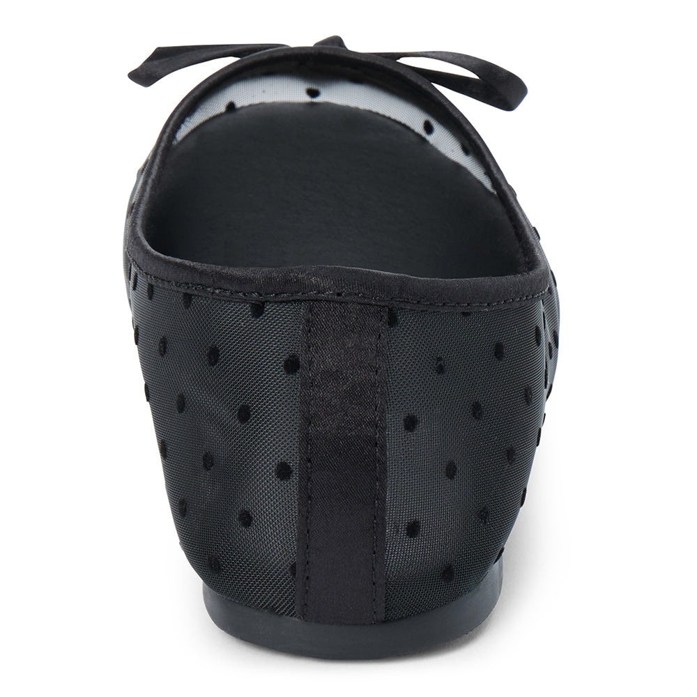 Vegan black sheer mesh ballet flat with black polka dots, a rounded toe, tonal trim, and small bow detail shown on a white background.