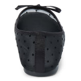 Vegan black sheer mesh ballet flat with black polka dots, a rounded toe, tonal trim, and small bow detail shown on a white background.