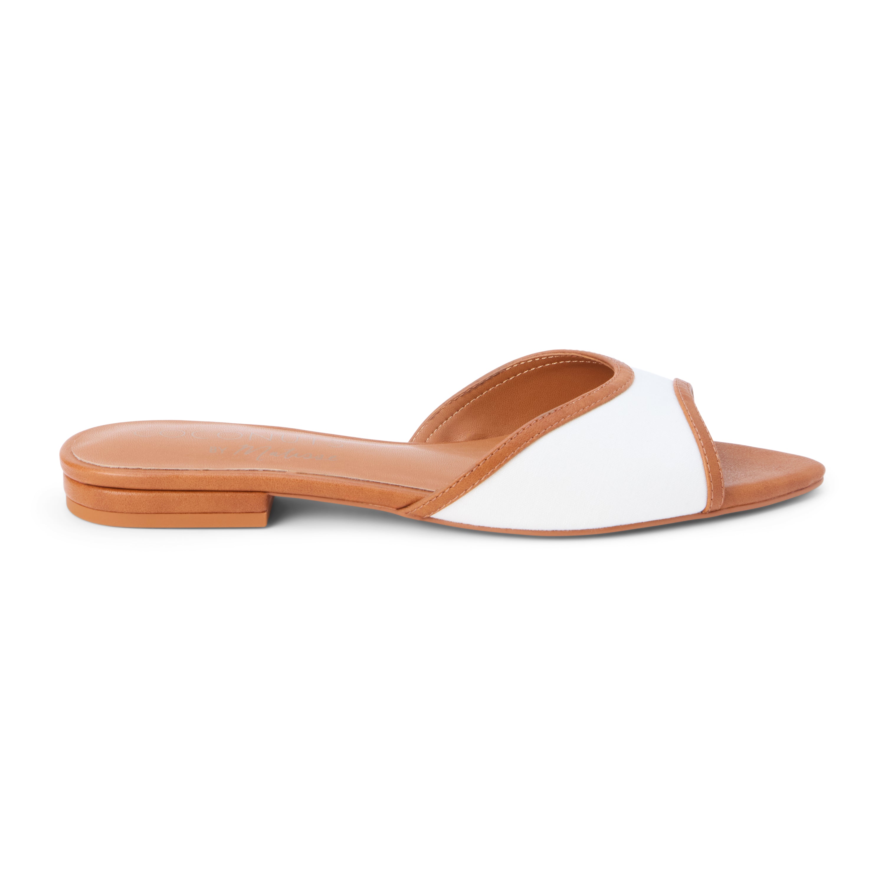 Tan and white vegan slide sandal with wide strap and low heel, shown on a white background.