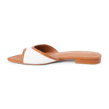 Tan and white vegan slide sandal with wide strap and low heel, shown on a white background.