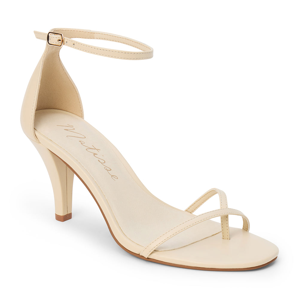 Ivory leather heeled sandal with a toe loop, slim ankle strap, and tapered heel shown on a white background.
