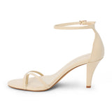 Ivory leather heeled sandal with a toe loop, slim ankle strap, and tapered heel shown on a white background.