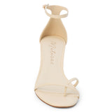 Ivory leather heeled sandal with a toe loop, slim ankle strap, and tapered heel shown on a white background.