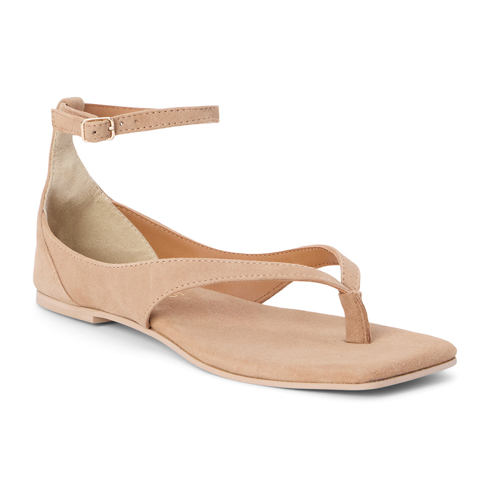 Tan suede sandal with ankle strap and toe thong shown on a white background.