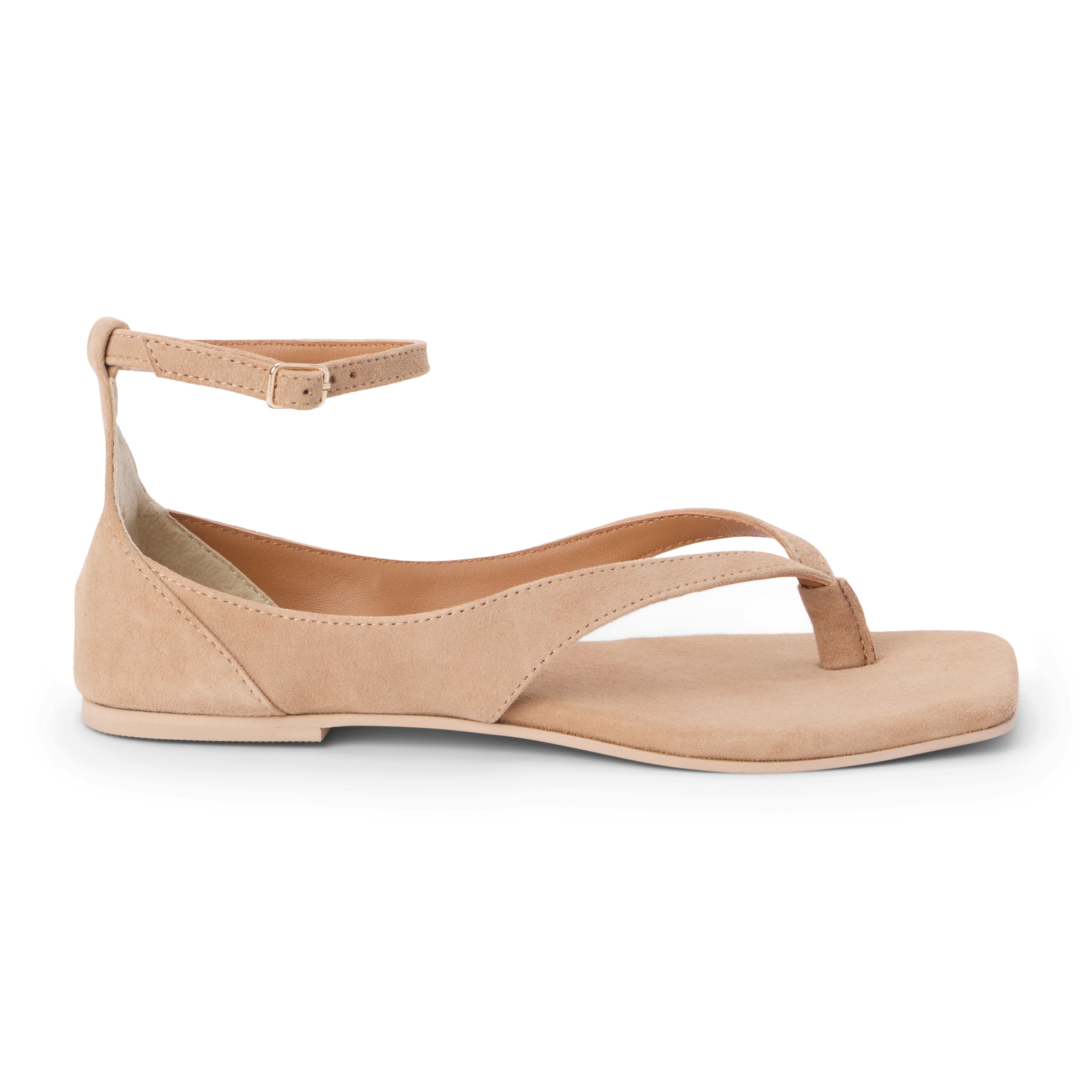 Tan suede sandal with ankle strap and toe thong shown on a white background.