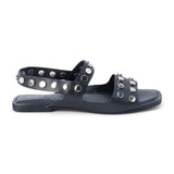 Black leather sandal with silver studs and slingback strap shown on a white background.