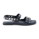 Black leather sandal with silver studs and slingback strap shown on a white background.