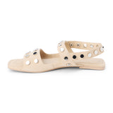 Ivory suede sandal with silver studs and slingback strap shown on a white background.