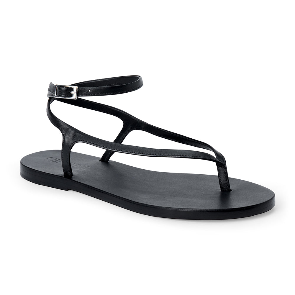 Black leather thong sandal with a minimalist strappy design and adjustable ankle buckle.