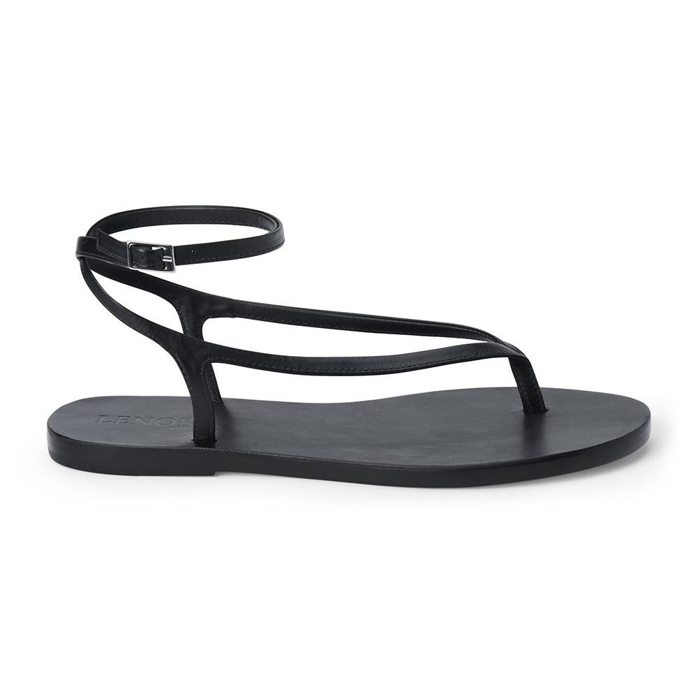 Black leather thong sandal with a minimalist strappy design and adjustable ankle buckle.